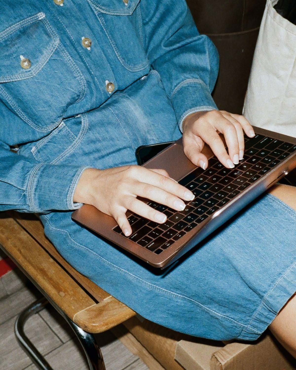 Operator processing wholesale orders on a laptop beside a packed delivery box